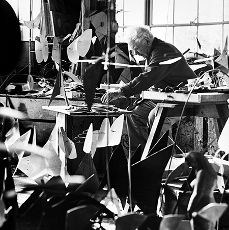 Calder at work in his studio, early 1960s. Image and Artwork: © 2021 Calder Foundation, New York / Artists Rights Society (ARS), New York